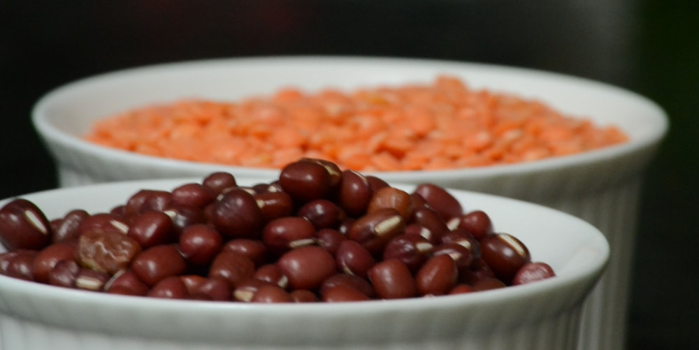 Healthy beans and lentils in white bowls
